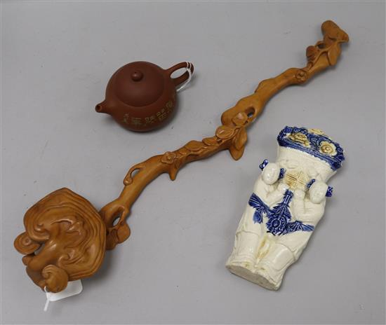 A Chinese wood ruyi sceptre, a Yixing teapot and a ceramic wall pocket ruyi sceptre length 47cm